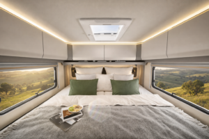 Wohnmobil Dachfenster abdichten: Mann prüft Dachfenster im Premium-Reisemobil